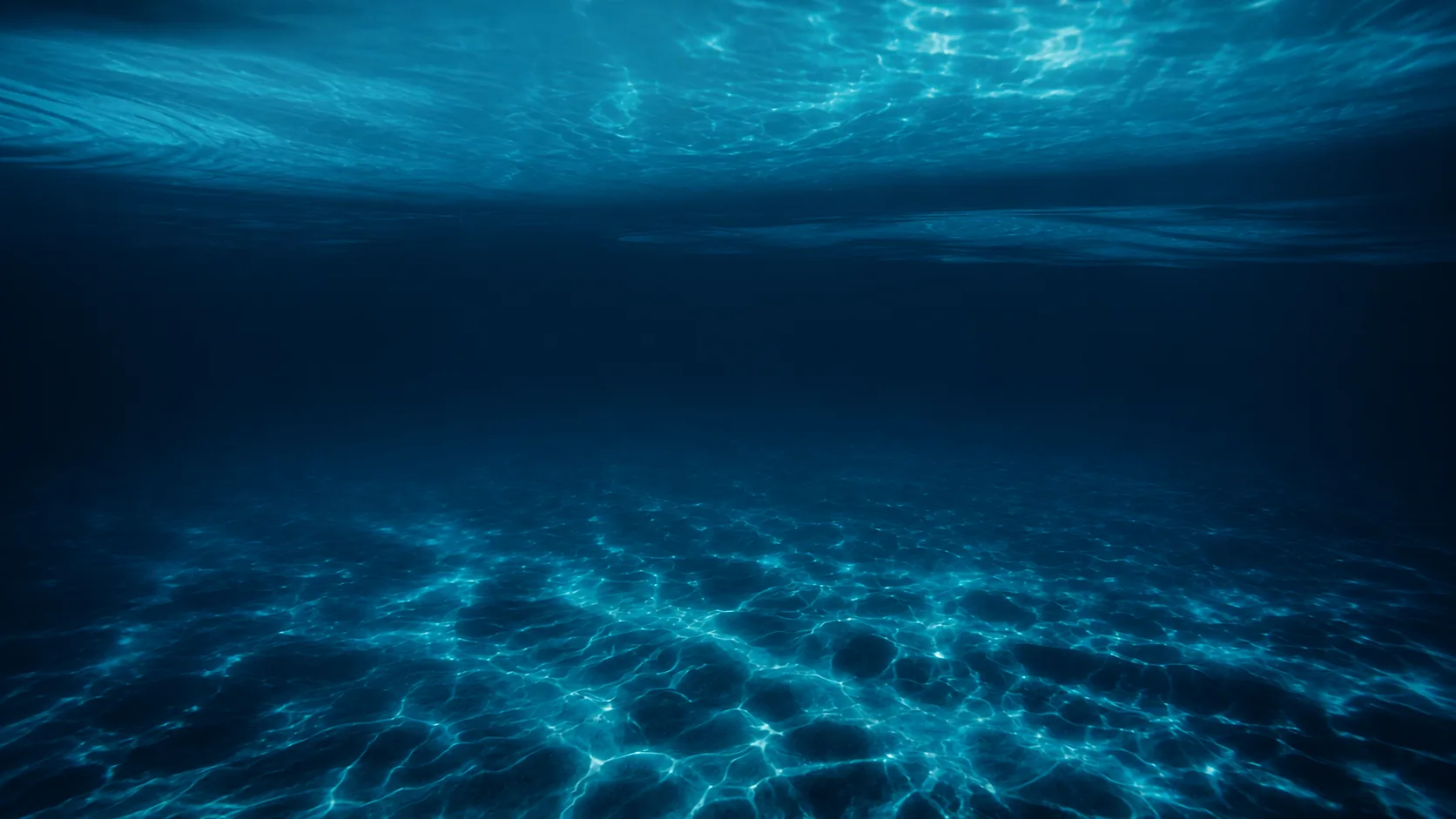 Sunlight caustics filtering through clear deep ocean waters